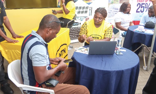Some patrons at the MTN stand at the opening ceremony