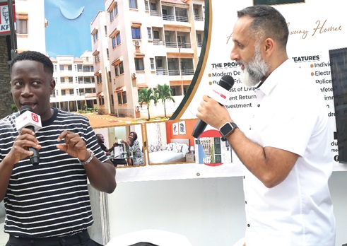 Kweku Zurek (left) Assistant Editor, Graphic Digital, speaking with a representative of Sethi Group