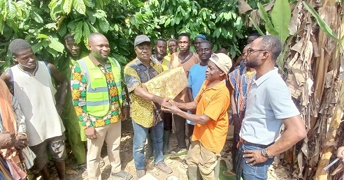 Dr Francis Baah (3rd from left), Deputy CEO of COCOBOD, presenting some cocoa products to Mohammed Yinchala during the visit