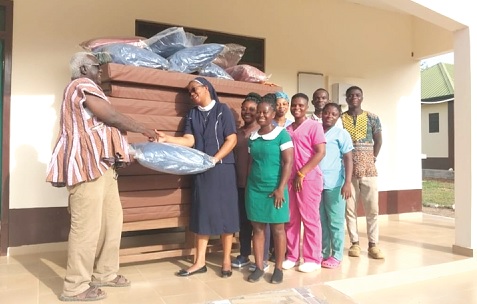 A representative of Sikkens Foundation presenting mattresses to the newly constructed Amankwakrom Health Centre