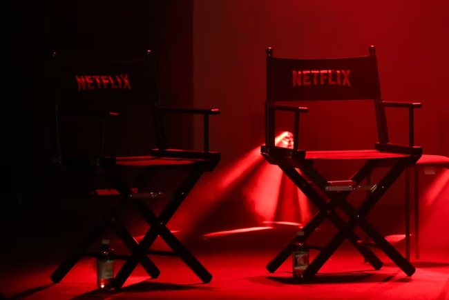 Two director's chairs with the Netflix logo sit on a stage at a convention in Lucca, Italy, October 31, 2025. REUTERS/Claudia Greco