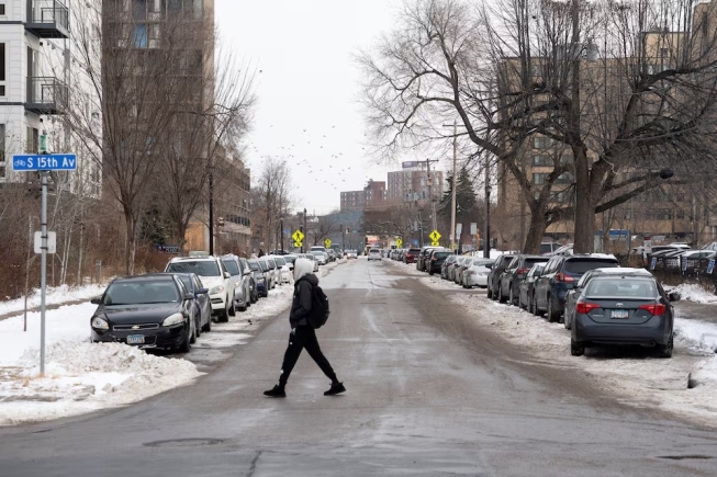 A man walks through the Cedar-Riverside neighborhood, a hub for Somali-American residents, amid reports of a planned federal operation targeting Somali immigrants, in Minneapolis, Minnesota, U.S., December 2, 2025. REUTERS/Tim Evans 