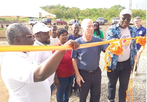 Dr Anthony Pile (2nd from right), Board Chairman of the foundation, being assisted by Alistair Djimatey (left), Head of Foundation and Corporate Affairs at Blue Skies; George Kafui Agbozo (right), Chairman of the Greenfield Mango Farmers Association, and Isaac Adjei Mensah, Regional Agriculture Extension Officer, to cut the tape to inaugurate the centre.