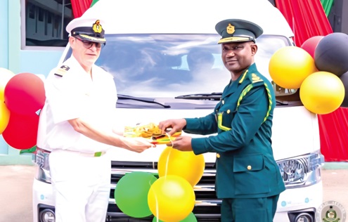Holger Grossman (5th from left), the German Defence Attaché to Ghana, presenting the items to Samuel Basintale Amadu, Comptroller General of Immigration