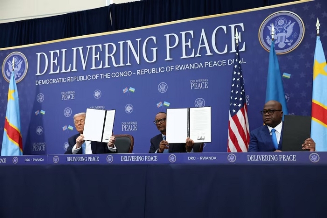 U.S. President Donald Trump, President of the Democratic Republic of the Congo Felix Tshisekedi and President of Rwanda Paul Kagame hold a signed document during a signing ceremony at the U.S. Institute of Peace in Washington, D.C., U.S., December 4, 2025. REUTERS/Kevin Lamarque