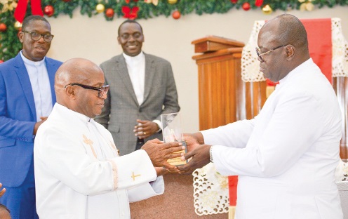Rt Rev. Dr Abraham Nana Kwakye Opare (right), Moderator of the Presbyterian Church of Ghana, presenting a gift to Rev. Dr Godwin Nii Noi Odonkor, the outgoing Clerk of the General Assembly of the church