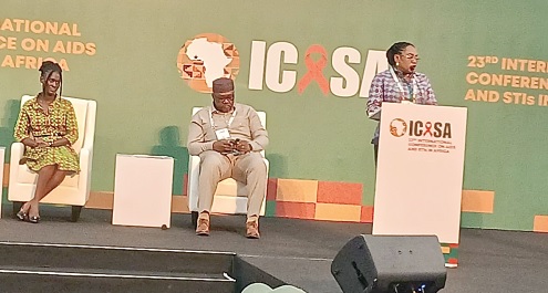 Dr Angela Ackon, Technical Officer, Quality and Safety of the WHO  Ghana Office, making her presentation, while Dr Mavis Boakye-Yiadom (seated left), Head, Department of Clinical Research of the Centre for Plant Medicine Research, Mampong Akuapem in the Eastern Region, and another official listen