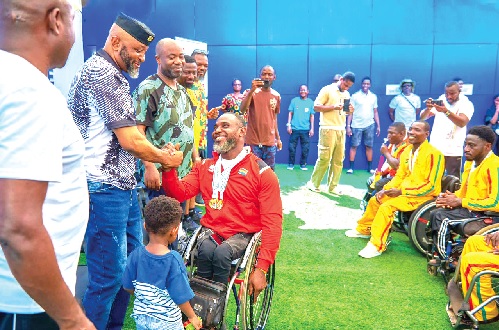Yaw Ampofo Ankrah, NSA boss exchanging pleasantries with Raphael Botsyo Nkegbe, one of the para athletes