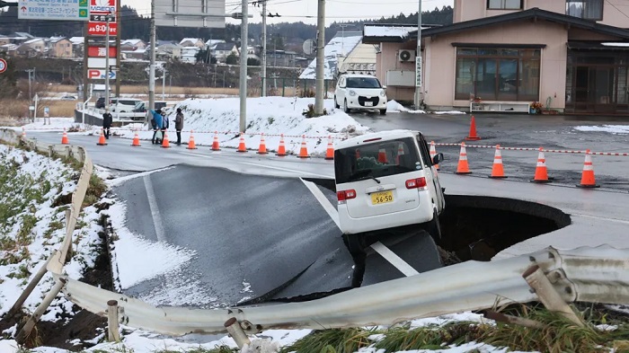A car is stranded on a collapsed road in Tohoku, Northern Japan