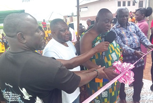 Nana Boakye Yiadom Karikari I,  (2nd from right), Otumfuo Nkofehene, being assisted by David Doku (2nd from left), Chairman, Unity Club, Belgium, and other officials to inaugurate the water facility. INSET: The newly constructed water system