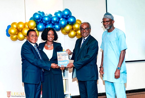 Justice Prof. Samuel Kofi Date-Bah (second from right), Retired Supreme Court judge, launching the book. With him are Dr Francisca Kusi-Appiah, the author; Justice Francis Kusi Appiah and Alhaji Jabaru Abukari, Director, Regional Operations and Consumer Services, PURC