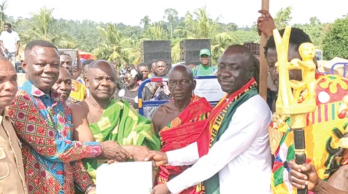 Petty Wilbert Brentum (left), Western North Regional Minister, and Okogyeman Kwaku III (2nd from left), Paramount Chief of Sefwi Chirano Traditional Area, presenting the award to Peter Adowa (right), the Western North Regional Best Farmer