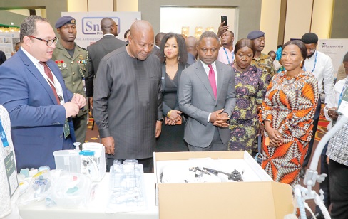 President John Mahama (2nd from left) inspecting some medical equipment exhibited at the forum. Looking on are Kwabena Mintah Akandoh (3rd from right), Minister of Health; Elizabeth Ofosu-Adjare (2nd from right), Minister of Trade, Agribusiness and Industry, and Dr Grace Ayensu-Danquah (right), Deputy Minister of Health, and  some dignitaries. Picture: ELVIS NII NOI DOWUONA 