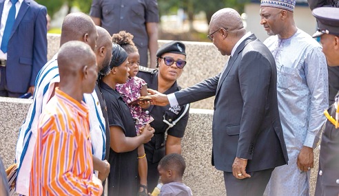 President John Dramani Mahama (2nd from right) consoling some family members of the fallen officers during the ceremony