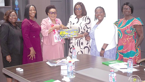 Lady Monica Wengam (3rd from right), President, Ministers Wives Association of Assemblies of God, Ghana, presenting a gift to First Lady Lordina Dramani Mahama (3rd from left)