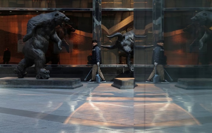 A street cleaner walks near sculptures at the foot of skyscrapers of the Moscow International Business Centre, also known as Moskva-City, in Moscow, Russia, October 2, 2025. REUTERS/Ramil Sitdikov/File Photo