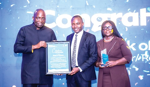 Shaibu Haruna (left), CEO, Mobile Money Ltd, presenting the Fintech Enabler/Regulator of the Year award to representatives of Bank of Ghana. Pictures: DOUGLAS ANANE-FRIMPONG