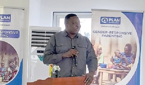 William Domapielle (left), Project Manager, Plan International Ghana's Integrated Package for Sustainable Development Project, speaking at the meeting