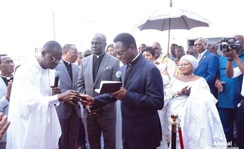 Joseph Siaw Agyepong (left) handing over the keys to Apostle Dr Eric Nyamekye, Chairman, Church of Pentecost, to dedicate the church (right)