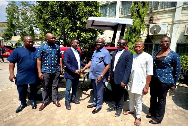 Mawuko Afadzinu (Center Left), Executive Head, Brand &amp; Marketing, Stanbic Bank Ghana handing over tractor to Honorable Eric Opoku (Center Right), Minister for Food and Agriculture,