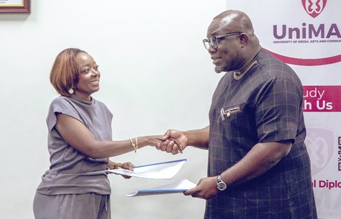 Professor Eric Opoku Mensah (right), VC, UniMAC, Mariam K. A Buahin, the Chief Operating Officer of the Akuna Group Ghana, exchanging documents after the signing