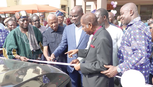 Haruna Iddrisu (3rd from left), Education Minister, being assisted by Prof. Mahama Duweijua  (2nd from left), Council Chairman of GTEC, to cut the ribbon for the presentation, while Prof. Ahmed Jinapor (right), Director-General, GTEC, looks on