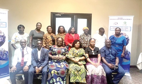 Gifty Sekyi-Bremansu (3rd from left), Head, Guidance and Counselling Unit, GES, and Melody Darkey (2nd from right), Executive Director, WiLDAF Ghana, with other participants in the meeting