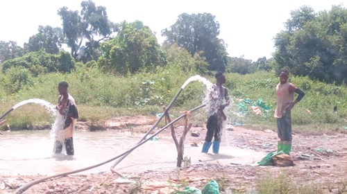 Some illegal miners bathing with the polluted water