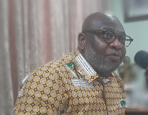 Dr Randy Abbey (inset), Chief Executive Officer of Ghana Cocoa Board, addressing some farmers at the meeting. Picture: ESTHER ADJORKOR ADJEI