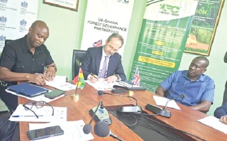 Dr Hugh C.A Brown (left), Chief Executive of the Forestry Commission, and Christian Rogg (2nd from left), British High Commissioner,  signing the MoU for their respective countries