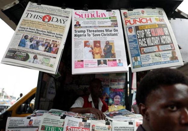 Newspapers with articles reporting U.S. President Donald Trump's message to Nigeria over the treatment of Christians hang at a newspaper stand in Ojuelegba, Lagos, Nigeria November 2, 2025. REUTERS/Sodiq Adelakun/File Photo
