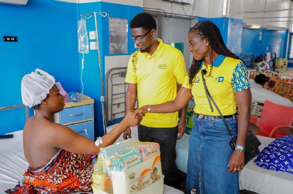 Adwoa Wiafe, Chief Corporate Services and Sustainability Officer of MTN Ghana, presents a hamper to a mother at the Maternity Ward of Korle Bu Teaching Hospital. With her is Samuel Bartels, Senior Manager for Regulatory and Government Affairs at MTN Ghana. Picture: ELVIS NII NOI DOWUONA