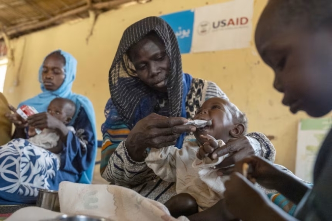 Rahma Kaki Jubarra and her sons, who are emergency level malnourished, Farah, 9 months and Jabr, three and a half, receive aid at Almanar feeding center in Mayo Mandala on the outskirts of Omdurman, Sudan on May 25, 2025. Carolyn Van Houten/The Washington Post/Getty Images