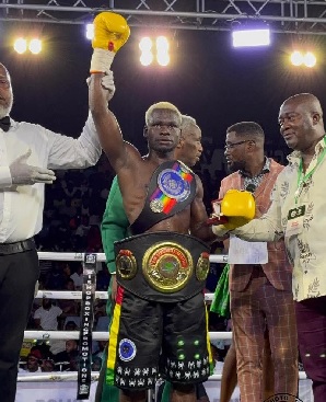 Michael Abban with arm raised after adding the WBA Pan African and Commonwealth Silver titles to his collection