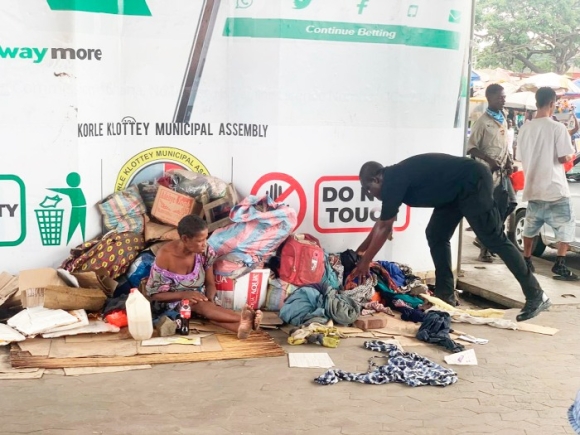 A member of the taskforce removing items of squatters