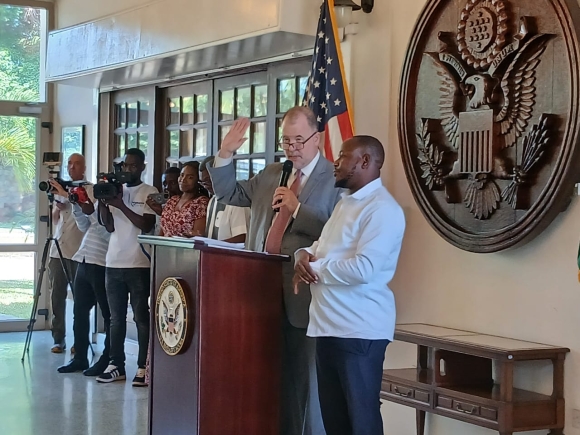 The Charge d'Affairs of the US Embassy, Rolf Olson, swearing them in 