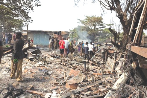  Some victims sifting through the remnants of their goods destroyed by the fire