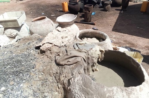 A pot with ash solutions where the  fresh skins are soaked to make it easy to remove the fur