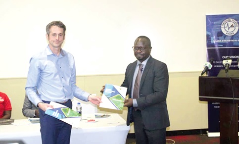 Prof. Kobina Annim (right), Government Statistician, and Dr James Tucker, Deputy Director of Health, International Pertnerships, ONS, UK exchanging documents Prof. Kobina Annim (right), Government Statistician, and Dr James Tucker, Deputy Director of Health, International Pertnerships, ONS, UK exchanging documents