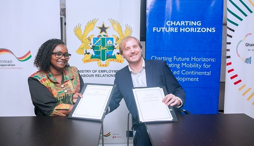 Wilhelm Hugo (right), Coordinator, Sustainable Economic Development Cluster at GIZ Ghana, exchanging the signed agreement with Fatou Ndiaye, Chief of Mission, IOM Ghana Wilhelm Hugo (right), Coordinator, Sustainable Economic Development Cluster at GIZ Ghana, exchanging the signed agreement with Fatou Ndiaye, Chief of Mission, IOM Ghana