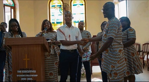 Ernest Afachao, the immediate past President of GAUA UniMAC Chapter, handing over UniMAC branded notepad to a student of Osu Presby SHS Ernest Afachao, the immediate past President of GAUA UniMAC Chapter, handing over UniMAC branded notepad to a student of Osu Presby SHS