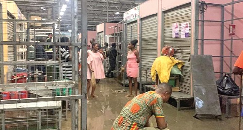 Some shop owners trying to clean up after water from a firefighting exercise at the Kejetia Market flooded their shops Some shop owners trying to clean up after water from a firefighting exercise at the Kejetia Market flooded their shops