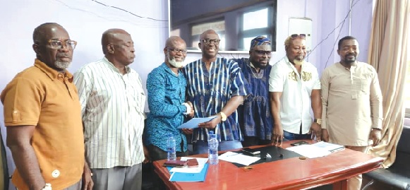 Abraham Kotei Neequaye (3rd from right) formally handing over documents to Roger Barnor (3rd from left), acting GBA President, in the presence of board members during the official transition ceremony