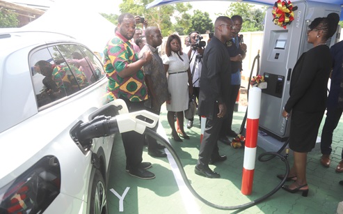 John Abdulai Jinapor, Minister of Energy and Green Transition, observing the EV Solar charging Station plant after the inauguration ceremony. With him is Eunice Biritwum, acting Chief Executive Secretary, Energy Commission. Picture: SAMUEL TEI ADANO 