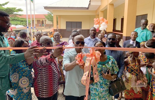 Prof. Augustine Fosu (middle) being assisted by Helen Fosu (right), his wife, to inaugurate the block