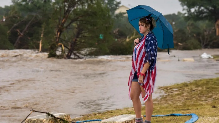 Kerrville resident Leighton Sterling watches flood waters along the Guadalupe River in Texas