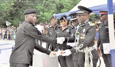 COP Daniel Kwame Afriyie (right), Director-General in charge of Private Security Operations of the Ghana Police Service, presenting the Baton-of-Honour to Emmanuel Amedome-Reigns, the overall best recruit COP Daniel Kwame Afriyie (right), Director-General in charge of Private Security Operations of the Ghana Police Service, presenting the Baton-of-Honour to Emmanuel Amedome-Reigns, the overall best recruit