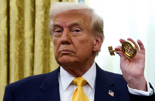 US President Donald Trump holds the key to the FIFA Club World Cup trophy in the Oval Office of the White House in Washington, D.C US President Donald Trump holds the key to the FIFA Club World Cup trophy in the Oval Office of the White House in Washington, D.C