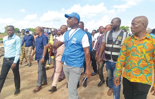 Samuel Dzikunu (in jacket), Head of Field Office of UNHCR, conducting the team from UNICEF and EU around the camp