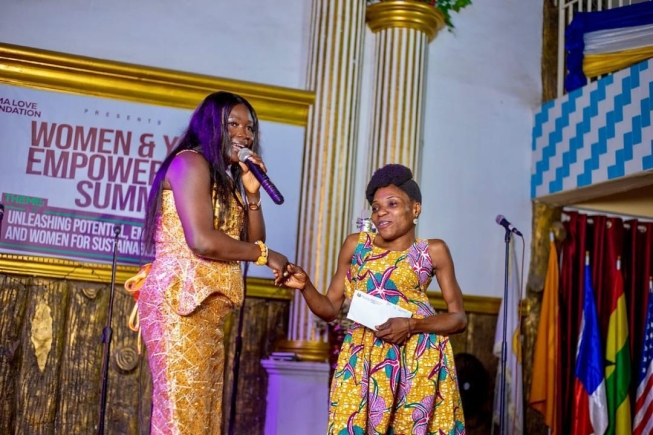 Rev. Love Konadu, President of the Mama Love Foundation, presenting an award to a physically-challenged lady for her contribution towards humanity. Mama Love Foundation supports widows, youth with start-up capital